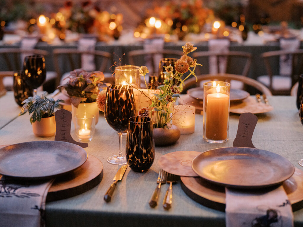 Stunning, autumnal ikebana centerpieces for a private birthday party in Nashville, TN. Each arrangement holds varying clusters of peach, burgundy and orange dahlias, spray roses, nigella, clematis pods, copper zinnias, red gem marigolds, salmon sweet peas, brown ranunculus, rose hips, explosion grass and lisianthus. Bright colors draw the eye to a beautiful table display surrounded by warm tea lights and woven pendants above. Design by Rosemary and Finch Floral Design in Nashville, TN. 