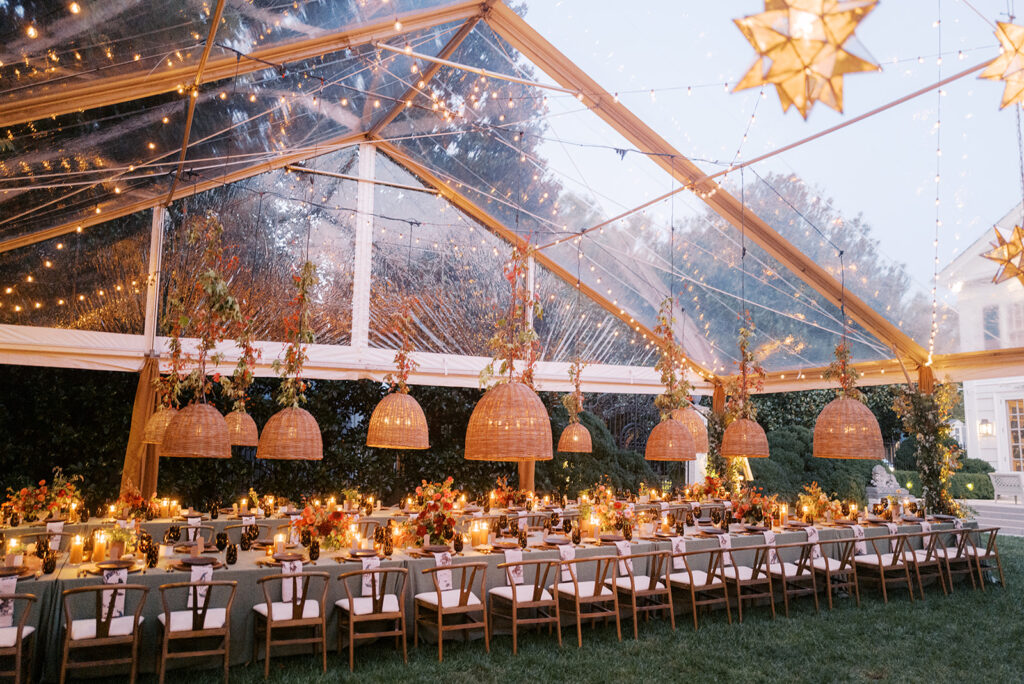 Gorgeous, flower-forward centerpiece arrangements for a private birthday party in Nashville, TN. Autumnal hues of red, brown, orange, pinks and cream are showcased in a stunning display of dahlias, zinnias, ranunculus, nigella, viburnum, rudbeckia, marigolds, liquid amber, spray roses, geranium, rose hips and bittersweet. Fall foliage provides greenery for arrangements and are wrapped around each tent pole and pendant. Design by Rosemary and Finch Floral Design in Nashville, TN. 