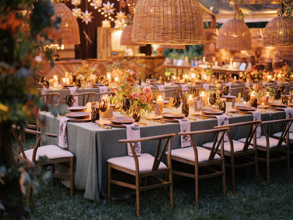 Gorgeous, flower-forward centerpiece arrangements for a private birthday party in Nashville, TN. Autumnal hues of red, brown, orange, pinks and cream are showcased in a stunning display of dahlias, zinnias, ranunculus, nigella, viburnum, rudbeckia, marigolds, liquid amber, spray roses, geranium, rose hips and bittersweet. Fall foliage provides greenery for arrangements and are wrapped around each tent pole and pendant. Design by Rosemary and Finch Floral Design in Nashville, TN. 