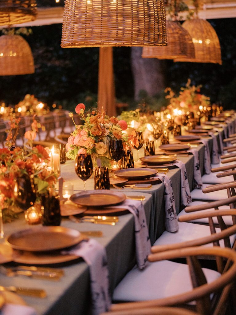Gorgeous, flower-forward centerpiece arrangements for a private birthday party in Nashville, TN. Autumnal hues of red, brown, orange, pinks and cream are showcased in a stunning display of dahlias, zinnias, ranunculus, nigella, viburnum, rudbeckia, marigolds, liquid amber, spray roses, geranium, rose hips and bittersweet. Fall foliage provides greenery for arrangements and are wrapped around each tent pole and pendant. Design by Rosemary and Finch Floral Design in Nashville, TN. 