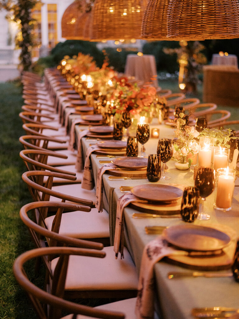 Gorgeous, flower-forward centerpiece arrangements for a private birthday party in Nashville, TN. Autumnal hues of red, brown, orange, pinks and cream are showcased in a stunning display of dahlias, zinnias, ranunculus, nigella, viburnum, rudbeckia, marigolds, liquid amber, spray roses, geranium, rose hips and bittersweet. Fall foliage provides greenery for arrangements and are wrapped around each tent pole and pendant. Design by Rosemary and Finch Floral Design in Nashville, TN. 