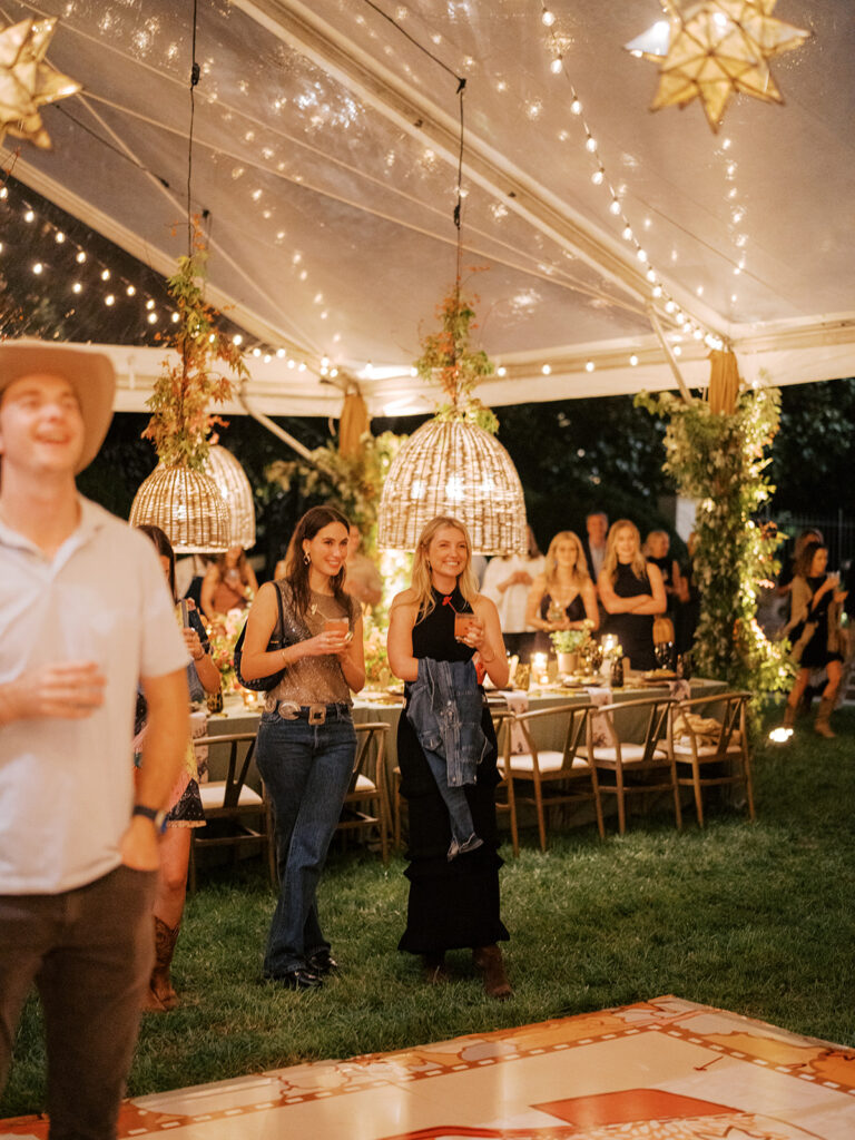 Gorgeous, flower-forward centerpiece arrangements for a private birthday party in Nashville, TN. Autumnal hues of red, brown, orange, pinks and cream are showcased in a stunning display of dahlias, zinnias, ranunculus, nigella, viburnum, rudbeckia, marigolds, liquid amber, spray roses, geranium, rose hips and bittersweet. Fall foliage provides greenery for arrangements and are wrapped around each tent pole and pendant. Design by Rosemary and Finch Floral Design in Nashville, TN. 