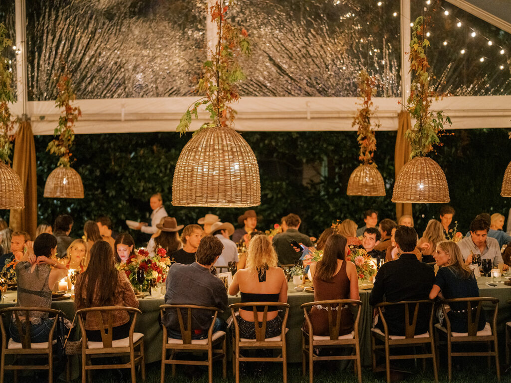 Gorgeous, flower-forward centerpiece arrangements for a private birthday party in Nashville, TN. Autumnal hues of red, brown, orange, pinks and cream are showcased in a stunning display of dahlias, zinnias, ranunculus, nigella, viburnum, rudbeckia, marigolds, liquid amber, spray roses, geranium, rose hips and bittersweet. Fall foliage provides greenery for arrangements and are wrapped around each tent pole and pendant. Design by Rosemary and Finch Floral Design in Nashville, TN. 