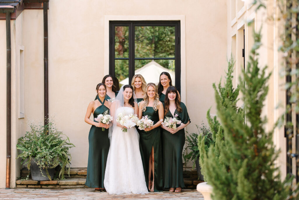 Simple and elegant all-white bridesmaid bouquets with hints of blush and pink for Belle Meade wedding in Nashville. Florals highlighted are dahlias, garden roses, majolika roses, ranunculus, butterfly ranunculus, clematis, sweet peas, astilbe, scabiosa, pieris, saponaria and minimal greenery. The white phalaenopsis creates a soft and bright focal moment for the bouquet. Design by Rosemary and Finch Floral Design in Nashville, TN. 