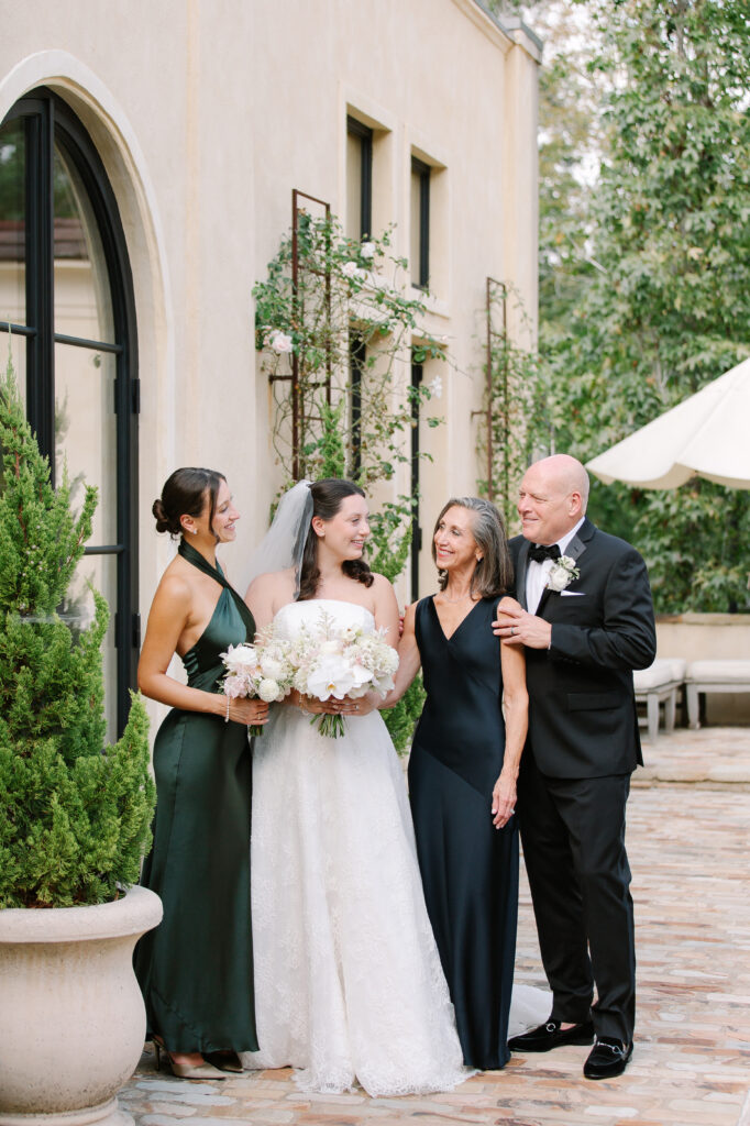 Stunning, elegant flower-forward all-white bridal bouquet with hints of blush and pink for Belle Meade wedding in Nashville. Florals highlighted are phalaenopsis, dahlias, garden roses, majolika roses, ranunculus, butterfly ranunculus, clematis, sweet peas, astilbe, scabiosa and light greenery. The white phalaenopsis creates a soft and bright focal moment for the bouquet. Design by Rosemary and Finch Floral Design in Nashville, TN. 