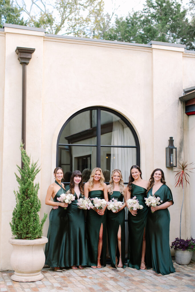 Simple and elegant all-white bridesmaid bouquets with hints of blush and pink for Belle Meade wedding in Nashville. Florals highlighted are dahlias, garden roses, majolika roses, ranunculus, butterfly ranunculus, clematis, sweet peas, astilbe, scabiosa, pieris, saponaria and minimal greenery. The white phalaenopsis creates a soft and bright focal moment for the bouquet. Design by Rosemary and Finch Floral Design in Nashville, TN. 