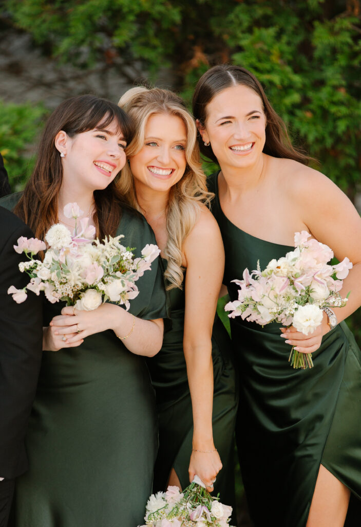 Simple and elegant all-white bridesmaid bouquets with hints of blush and pink for Belle Meade wedding in Nashville. Florals highlighted are dahlias, garden roses, majolika roses, ranunculus, butterfly ranunculus, clematis, sweet peas, astilbe, scabiosa, pieris, saponaria and minimal greenery. The white phalaenopsis creates a soft and bright focal moment for the bouquet. Design by Rosemary and Finch Floral Design in Nashville, TN. 