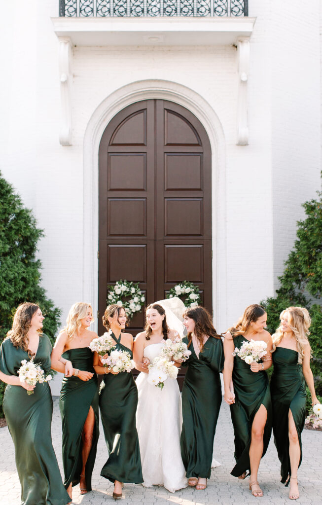 Simple and elegant all-white bridesmaid bouquets with hints of blush and pink for Belle Meade wedding in Nashville. Florals highlighted are dahlias, garden roses, majolika roses, ranunculus, butterfly ranunculus, clematis, sweet peas, astilbe, scabiosa, pieris, saponaria and minimal greenery. The white phalaenopsis creates a soft and bright focal moment for the bouquet. Design by Rosemary and Finch Floral Design in Nashville, TN. 
