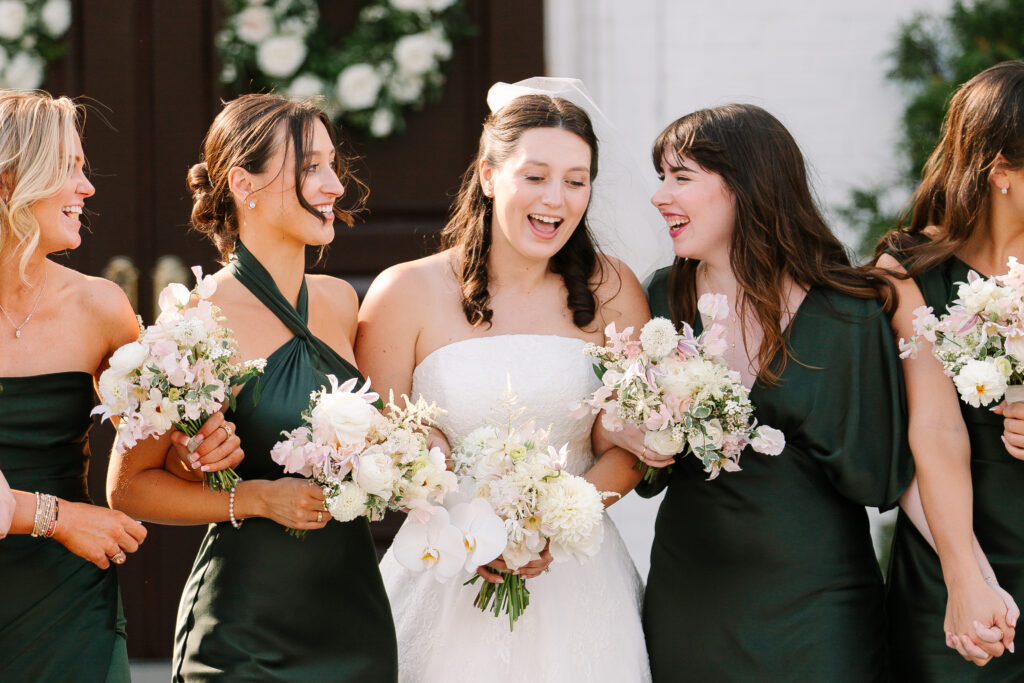 Stunning, elegant flower-forward all-white bridal bouquet with hints of blush and pink for Belle Meade wedding in Nashville. Florals highlighted are phalaenopsis, dahlias, garden roses, majolika roses, ranunculus, butterfly ranunculus, clematis, sweet peas, astilbe, scabiosa and light greenery. The white phalaenopsis creates a soft and bright focal moment for the bouquet. Design by Rosemary and Finch Floral Design in Nashville, TN. 