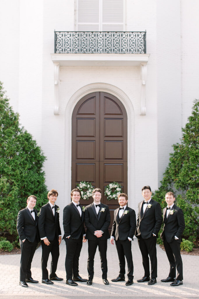 Simple boutonnieres consisting of all white majolikas, ranunculus, pieris and light greenery. Design by Rosemary and Finch Floral Design in Nashville, TN. 