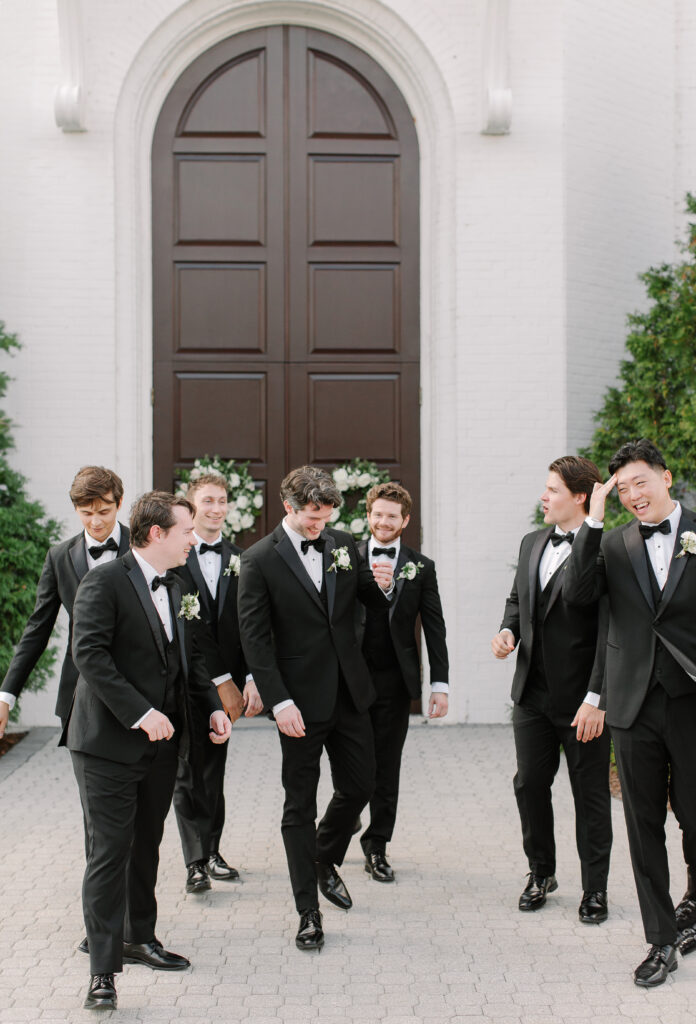 Simple boutonnieres consisting of all white majolikas, ranunculus, pieris and light greenery. Design by Rosemary and Finch Floral Design in Nashville, TN. 