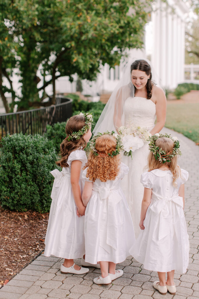 Stunning, elegant flower-forward all-white bridal bouquet with hints of blush and pink for Belle Meade wedding in Nashville. Florals highlighted are phalaenopsis, dahlias, garden roses, majolika roses, ranunculus, butterfly ranunculus, clematis, sweet peas, astilbe, scabiosa and light greenery. The white phalaenopsis creates a soft and bright focal moment for the bouquet. Design by Rosemary and Finch Floral Design in Nashville, TN. 