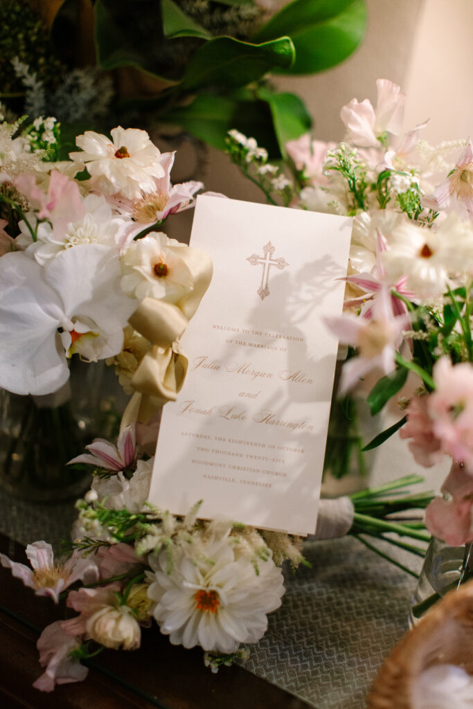 Stunning, elegant flower-forward all-white bridal bouquet with hints of blush and pink for Belle Meade wedding in Nashville. Florals highlighted are phalaenopsis, dahlias, garden roses, majolika roses, ranunculus, butterfly ranunculus, clematis, sweet peas, astilbe, scabiosa and light greenery. The white phalaenopsis creates a soft and bright focal moment for the bouquet. Design by Rosemary and Finch Floral Design in Nashville, TN. 