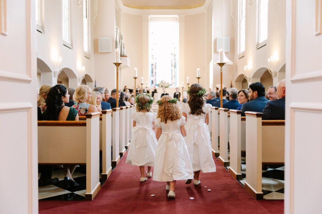 Stunning, elegant flower-forward all-white bridal bouquet with hints of blush and pink for Belle Meade wedding in Nashville. Florals highlighted are phalaenopsis, dahlias, garden roses, majolika roses, ranunculus, butterfly ranunculus, clematis, sweet peas, astilbe, scabiosa and light greenery. The white phalaenopsis creates a soft and bright focal moment for the bouquet. Design by Rosemary and Finch Floral Design in Nashville, TN. 