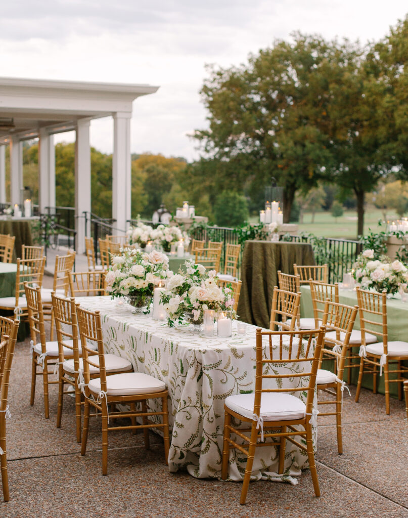 Lush and elegant floral centerpieces for Nashville wedding at Hillwood Country Club. Light pinks, blush and white florals consist of dahlias, garden roses, playa blancas, quicksand roses, ranunculus, lisianthus, majolikas, pieris, delphinium, sweet peas, saponaria, clematis, astilbe, and contrasting greenery. Centerpieces were accompanied by warm candlelight and lush vines growing near the bar for a beautiful wedding reception. Design by Rosemary and Finch Floral Design in Nashville, TN. 