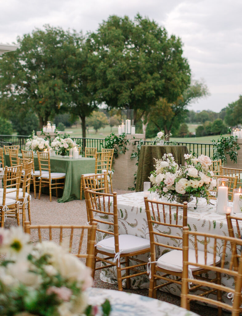 Lush and elegant floral centerpieces for Nashville wedding at Hillwood Country Club. Light pinks, blush and white florals consist of dahlias, garden roses, playa blancas, quicksand roses, ranunculus, lisianthus, majolikas, pieris, delphinium, sweet peas, saponaria, clematis, astilbe, and contrasting greenery. Centerpieces were accompanied by warm candlelight and lush vines growing near the bar for a beautiful wedding reception. Design by Rosemary and Finch Floral Design in Nashville, TN. 