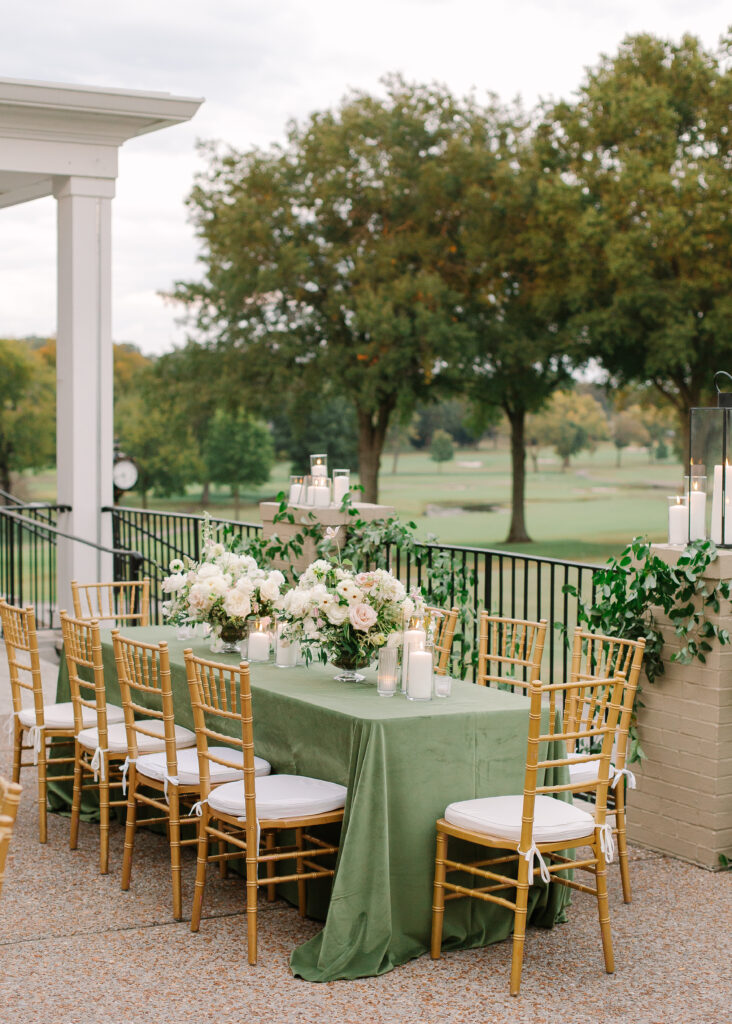 Lush and elegant floral centerpieces for Nashville wedding at Hillwood Country Club. Light pinks, blush and white florals consist of dahlias, garden roses, playa blancas, quicksand roses, ranunculus, lisianthus, majolikas, pieris, delphinium, sweet peas, saponaria, clematis, astilbe, and contrasting greenery. Centerpieces were accompanied by warm candlelight and lush vines growing near the bar for a beautiful wedding reception. Design by Rosemary and Finch Floral Design in Nashville, TN. 