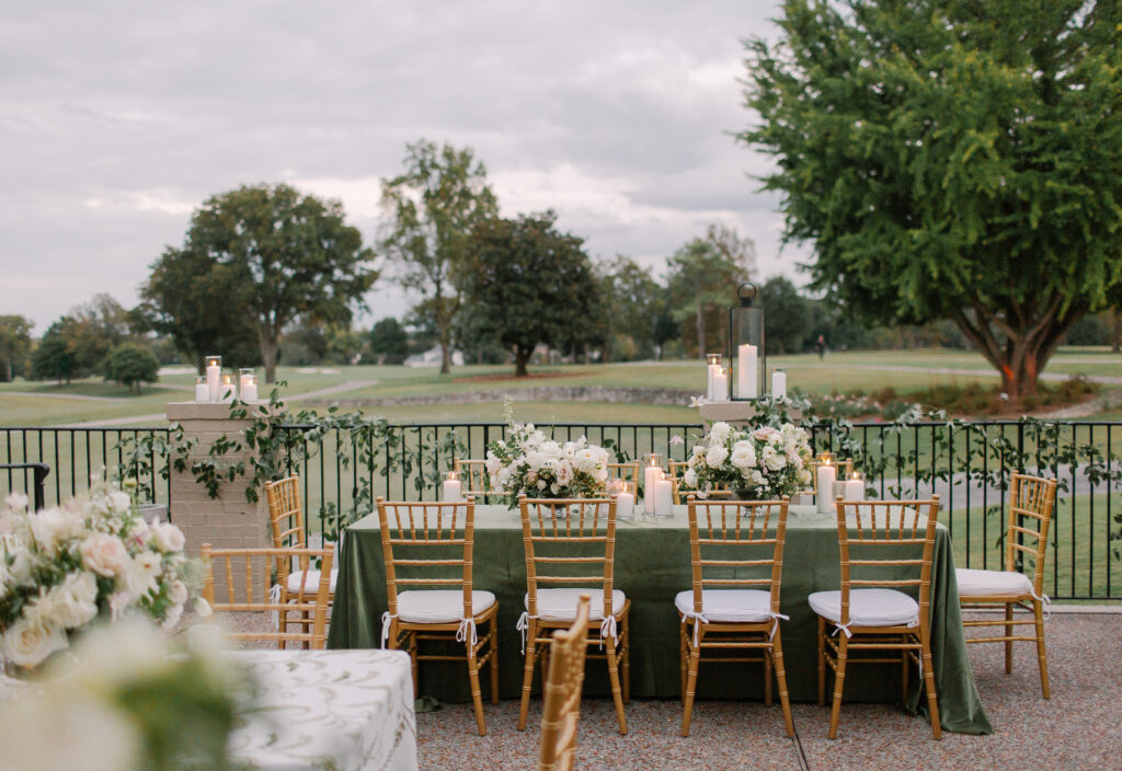 Lush and elegant floral centerpieces for Nashville wedding at Hillwood Country Club. Light pinks, blush and white florals consist of dahlias, garden roses, playa blancas, quicksand roses, ranunculus, lisianthus, majolikas, pieris, delphinium, sweet peas, saponaria, clematis, astilbe, and contrasting greenery. Centerpieces were accompanied by warm candlelight and lush vines growing near the bar for a beautiful wedding reception. Design by Rosemary and Finch Floral Design in Nashville, TN. 