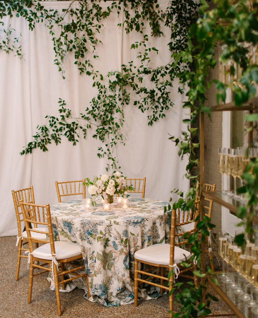 Lush and elegant floral centerpieces for Nashville wedding at Hillwood Country Club. Light pinks, blush and white florals consist of dahlias, garden roses, playa blancas, quicksand roses, ranunculus, lisianthus, majolikas, pieris, delphinium, sweet peas, saponaria, clematis, astilbe, and contrasting greenery. Centerpieces were accompanied by warm candlelight and lush vines growing near the bar for a beautiful wedding reception. Design by Rosemary and Finch Floral Design in Nashville, TN. 