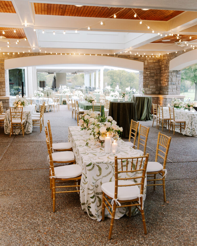 Lush and elegant floral centerpieces for Nashville wedding at Hillwood Country Club. Light pinks, blush and white florals consist of dahlias, garden roses, playa blancas, quicksand roses, ranunculus, lisianthus, majolikas, pieris, delphinium, sweet peas, saponaria, clematis, astilbe, and contrasting greenery. Centerpieces were accompanied by warm candlelight and lush vines growing near the bar for a beautiful wedding reception. Design by Rosemary and Finch Floral Design in Nashville, TN. 