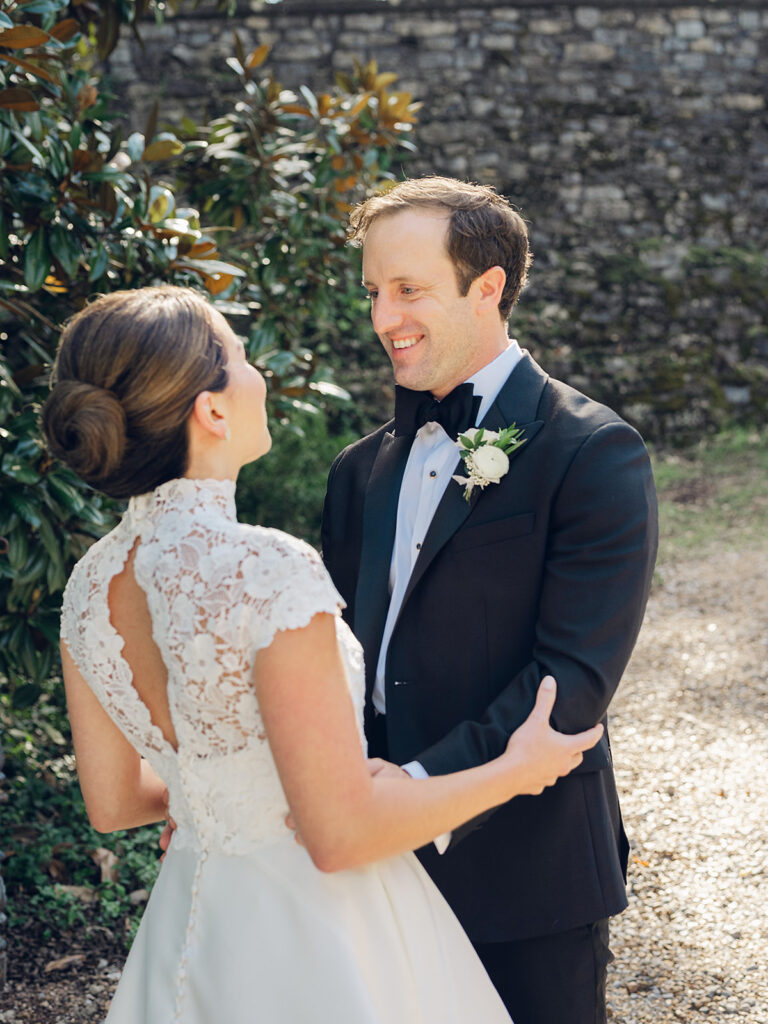 Romantic, editorial bridal bouquet featuring all-white garden roses, cloud roses, sweet peas, spray roses, ranunculus, and lisianthus accompanied by olive branches and light greenery. Soft and romantic bouquet to highlight elegance of a botanical tented wedding at Cheekwood. Design by Rosemary & Finch Floral Design in Nashville, TN.