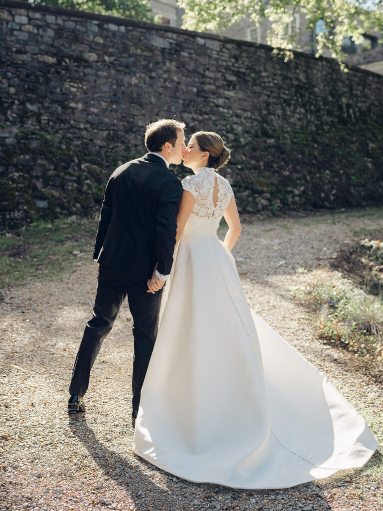 Romantic, editorial bridal bouquet featuring all-white garden roses, cloud roses, sweet peas, spray roses, ranunculus, and lisianthus accompanied by olive branches and light greenery. Soft and romantic bouquet to highlight elegance of a botanical tented wedding at Cheekwood. Design by Rosemary & Finch Floral Design in Nashville, TN.