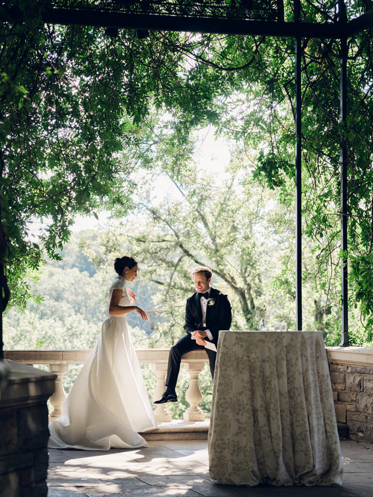Romantic, editorial bridal bouquet featuring all-white garden roses, cloud roses, sweet peas, spray roses, ranunculus, and lisianthus accompanied by olive branches and light greenery. Soft and romantic bouquet to highlight elegance of a botanical tented wedding at Cheekwood. Design by Rosemary & Finch Floral Design in Nashville, TN.