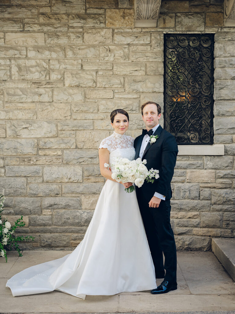 Romantic, editorial bridal bouquet featuring all-white garden roses, cloud roses, sweet peas, spray roses, ranunculus, and lisianthus accompanied by olive branches and light greenery. Soft and romantic bouquet to highlight elegance of a botanical tented wedding at Cheekwood. Design by Rosemary & Finch Floral Design in Nashville, TN.