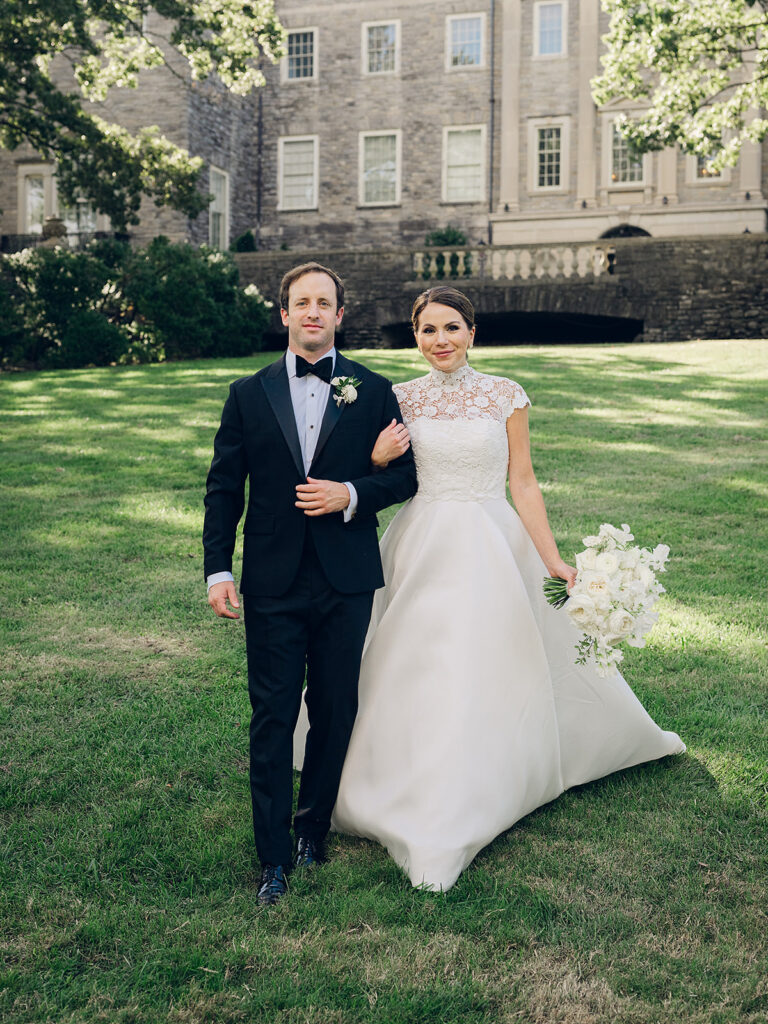 Romantic, editorial bridal bouquet featuring all-white garden roses, cloud roses, sweet peas, spray roses, ranunculus, and lisianthus accompanied by olive branches and light greenery. Soft and romantic bouquet to highlight elegance of a botanical tented wedding at Cheekwood. Design by Rosemary & Finch Floral Design in Nashville, TN.