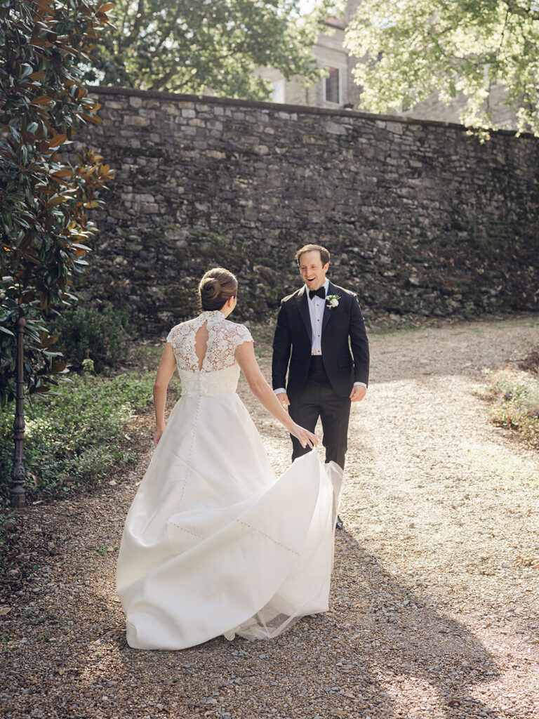 Romantic, editorial bridal bouquet featuring all-white garden roses, cloud roses, sweet peas, spray roses, ranunculus, and lisianthus accompanied by olive branches and light greenery. Soft and romantic bouquet to highlight elegance of a botanical tented wedding at Cheekwood. Design by Rosemary & Finch Floral Design in Nashville, TN.