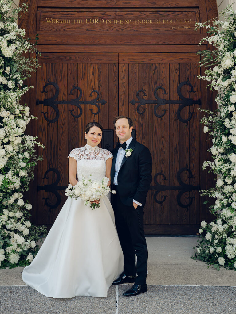 Romantic, editorial bridal bouquet featuring all-white garden roses, cloud roses, sweet peas, spray roses, ranunculus, and lisianthus accompanied by olive branches and light greenery. Soft and romantic bouquet to highlight elegance of a botanical tented wedding at Cheekwood. Design by Rosemary & Finch Floral Design in Nashville, TN.