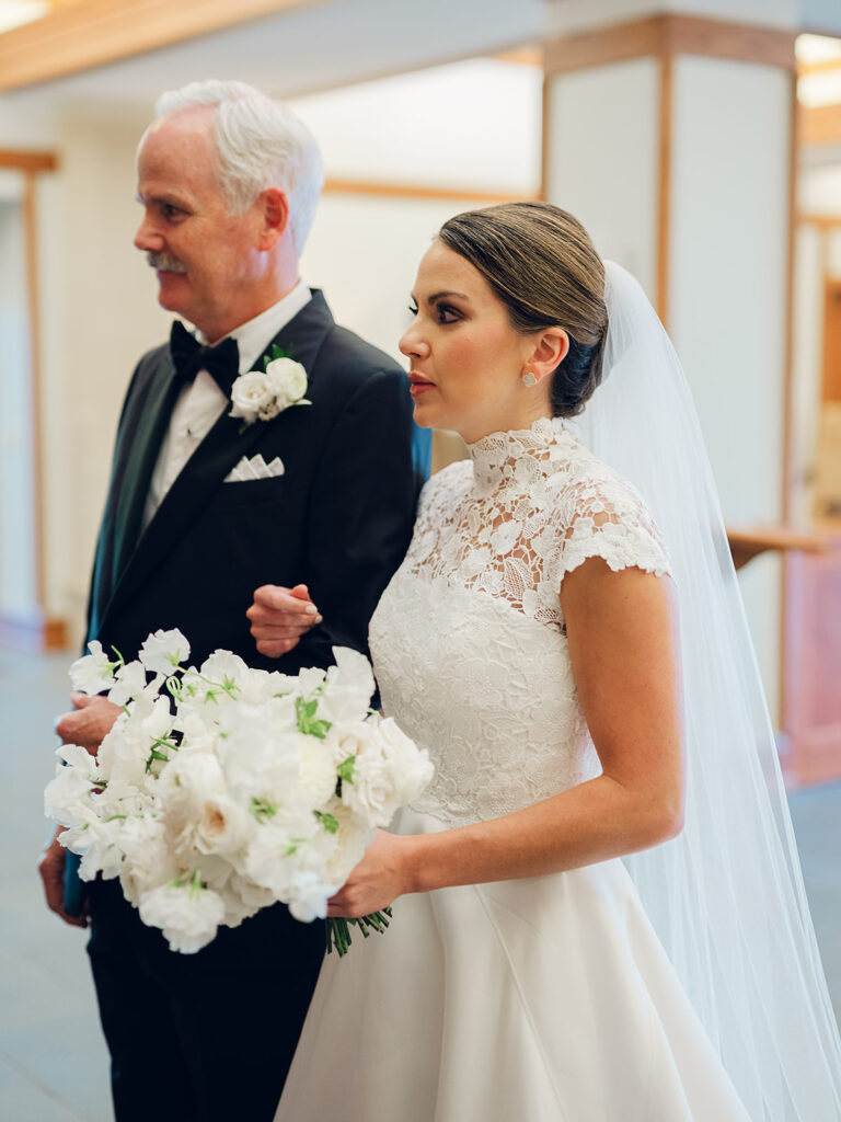 Romantic, editorial bridal bouquet featuring all-white garden roses, cloud roses, sweet peas, spray roses, ranunculus, and lisianthus accompanied by olive branches and light greenery. Soft and romantic bouquet to highlight elegance of a botanical tented wedding at Cheekwood. Design by Rosemary & Finch Floral Design in Nashville, TN.
