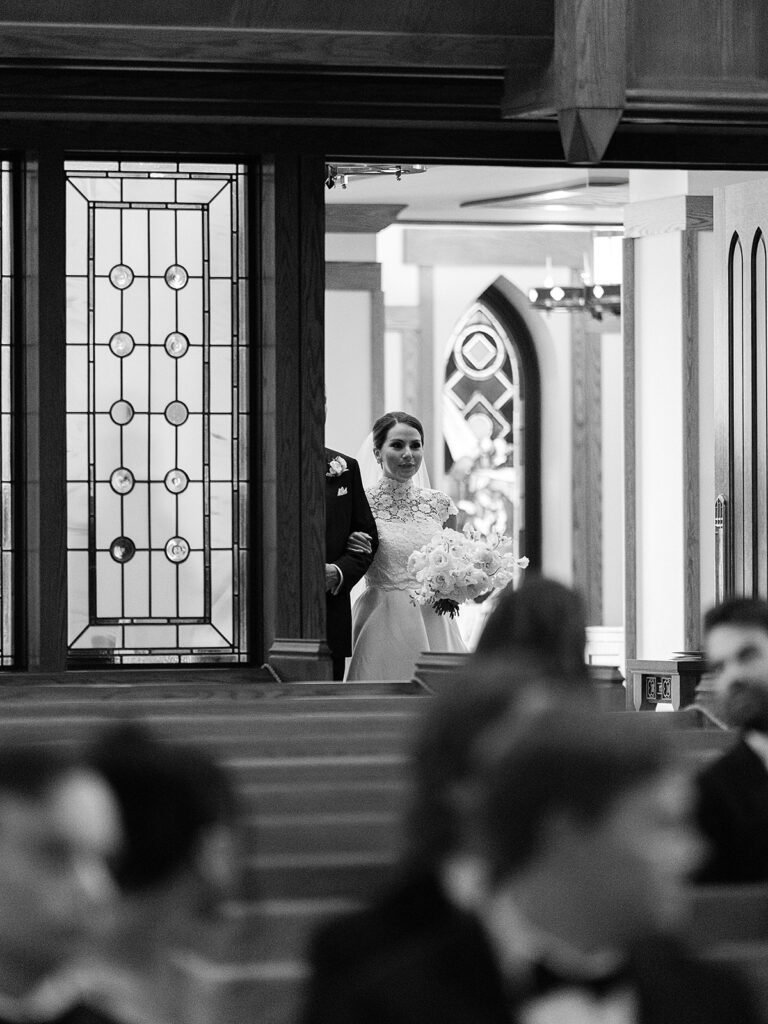 Romantic, editorial bridal bouquet featuring all-white garden roses, cloud roses, sweet peas, spray roses, ranunculus, and lisianthus accompanied by olive branches and light greenery. Soft and romantic bouquet to highlight elegance of a botanical tented wedding at Cheekwood. Design by Rosemary & Finch Floral Design in Nashville, TN.