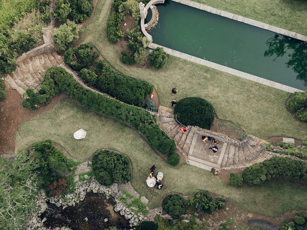 Simple and elegant floral arrangements for Cheekwood cocktail hour consisting of all-white bar arrangements and simple bud vases. Double tulips, hydrangeas, cloud and spray roses, delphinium, allium, riceflower, ranunculus, lisianthus, and white stock are used to create stunning floral moments scattered throughout the cocktail hour patio and bars. Design by Rosemary & Finch Floral Design in Nashville, TN.