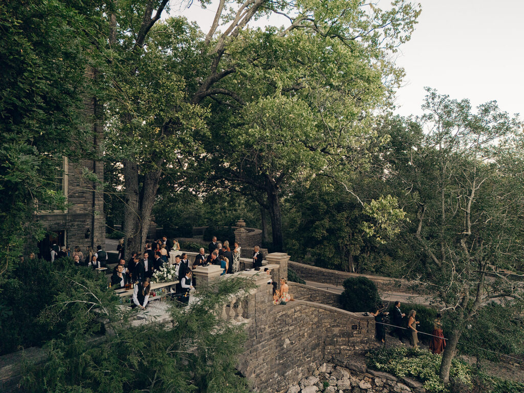 Simple and elegant floral arrangements for Cheekwood cocktail hour consisting of all-white bar arrangements and simple bud vases. Double tulips, hydrangeas, cloud and spray roses, delphinium, allium, riceflower, ranunculus, lisianthus, and white stock are used to create stunning floral moments scattered throughout the cocktail hour patio and bars. Design by Rosemary & Finch Floral Design in Nashville, TN.