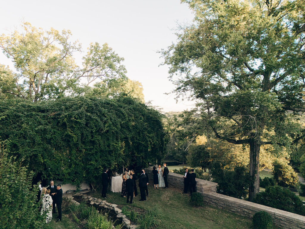 Simple and elegant floral arrangements for Cheekwood cocktail hour consisting of all-white bar arrangements and simple bud vases. Double tulips, hydrangeas, cloud and spray roses, delphinium, allium, riceflower, ranunculus, lisianthus, and white stock are used to create stunning floral moments scattered throughout the cocktail hour patio and bars. Design by Rosemary & Finch Floral Design in Nashville, TN.