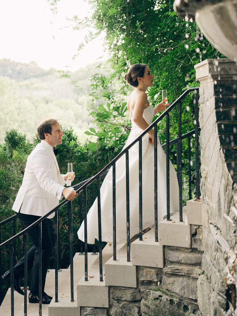 Simple and elegant floral arrangements for Cheekwood cocktail hour consisting of all-white bar arrangements and simple bud vases. Double tulips, hydrangeas, cloud and spray roses, delphinium, allium, riceflower, ranunculus, lisianthus, and white stock are used to create stunning floral moments scattered throughout the cocktail hour patio and bars. Design by Rosemary & Finch Floral Design in Nashville, TN.