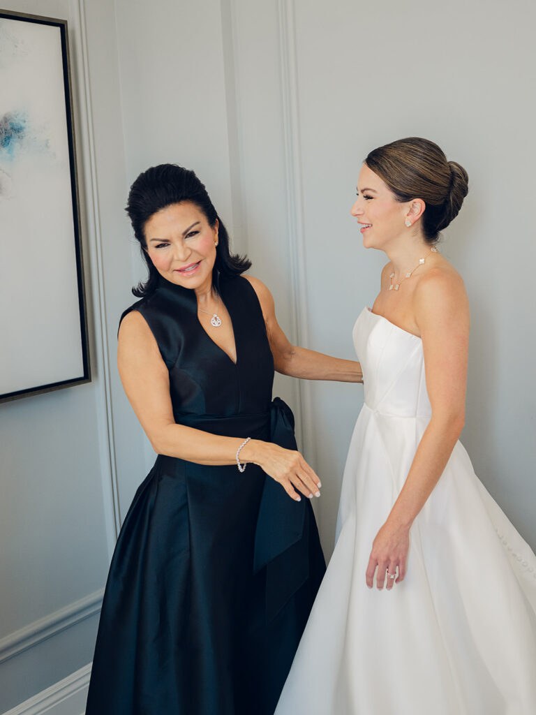 Romantic, editorial bridal bouquet featuring all-white garden roses, cloud roses, sweet peas, spray roses, ranunculus, and lisianthus accompanied by olive branches and light greenery. Soft and romantic bouquet to highlight elegance of a botanical tented wedding at Cheekwood. Design by Rosemary & Finch Floral Design in Nashville, TN.