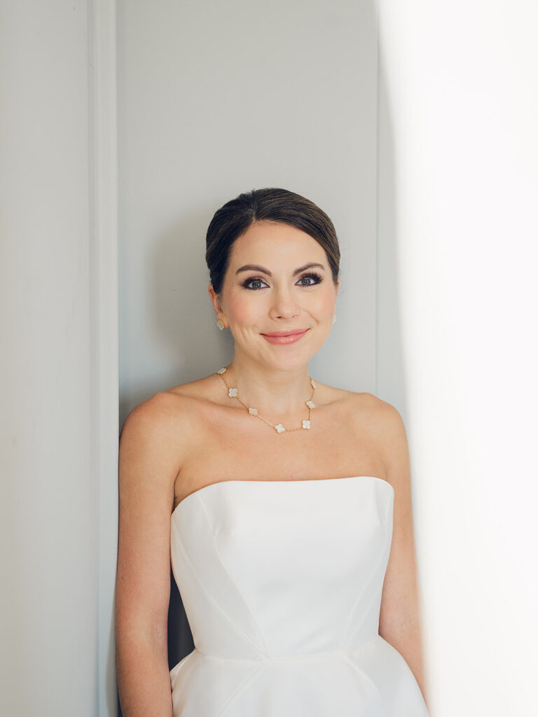 Romantic, editorial bridal bouquet featuring all-white garden roses, cloud roses, sweet peas, spray roses, ranunculus, and lisianthus accompanied by olive branches and light greenery. Soft and romantic bouquet to highlight elegance of a botanical tented wedding at Cheekwood. Design by Rosemary & Finch Floral Design in Nashville, TN.
