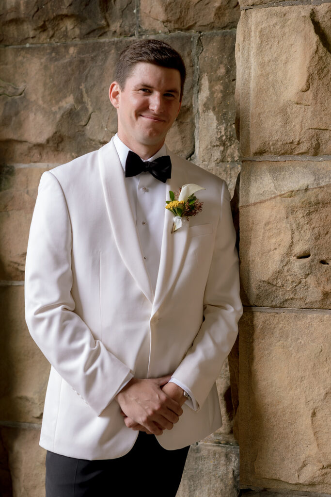 Colorful and bright bridesmaid bouquets for Sewanee wedding consisting of white calla lilies, apricot lisianthus, peach tulips, yellow butterfly ranunculus, yellow oncidium orchids and ranunculus in shades of orange, yellow and peach. Flower girl crowns match the same design as the bridesmaid bouquets. Fun, yet simple arrangements for a late summer wedding. Design by Rosemary and Finch Floral Design in Nashville, TN. 