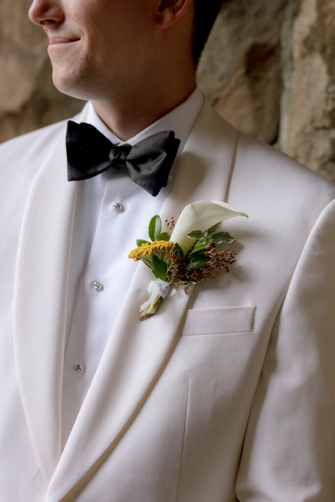 Colorful and bright bridesmaid bouquets for Sewanee wedding consisting of white calla lilies, apricot lisianthus, peach tulips, yellow butterfly ranunculus, yellow oncidium orchids and ranunculus in shades of orange, yellow and peach. Flower girl crowns match the same design as the bridesmaid bouquets. Fun, yet simple arrangements for a late summer wedding. Design by Rosemary and Finch Floral Design in Nashville, TN. 