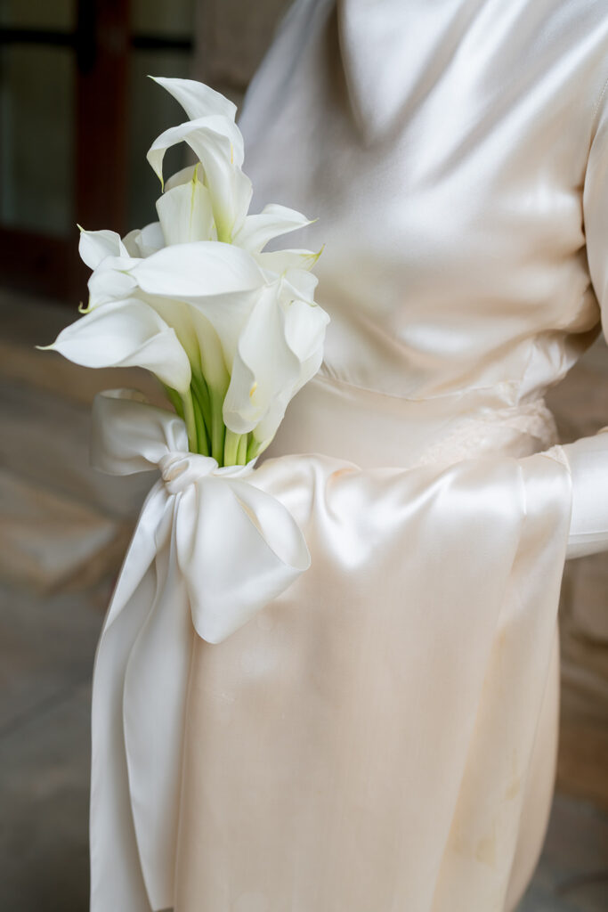 A simple and modest bouquet consisting of all white calla lilies wrapped in ivory silk. An elegant and classic touch to a beautiful summer wedding in Sewanee, TN. Design by Rosemary and Finch Floral Design in Nashville, TN. 