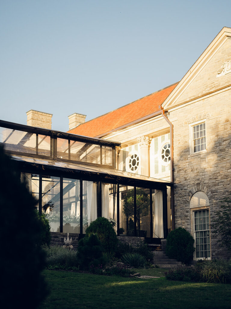 Simple and elegant floral arrangements for Cheekwood cocktail hour consisting of all-white bar arrangements and simple bud vases. Double tulips, hydrangeas, cloud and spray roses, delphinium, allium, riceflower, ranunculus, lisianthus, and white stock are used to create stunning floral moments scattered throughout the cocktail hour patio and bars. Design by Rosemary & Finch Floral Design in Nashville, TN.