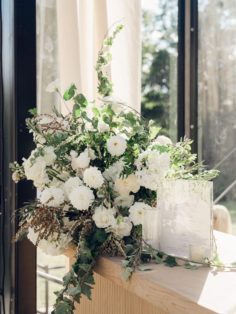 Simple and elegant floral arrangements for Cheekwood reception consisting of all-white bar arrangements. Double tulips, hydrangeas, cloud and spray roses, delphinium, allium, riceflower, ranunculus, lisianthus, and white stock are used to create stunning floral moments for the reception bars. Design by Rosemary & Finch Floral Design in Nashville, TN.